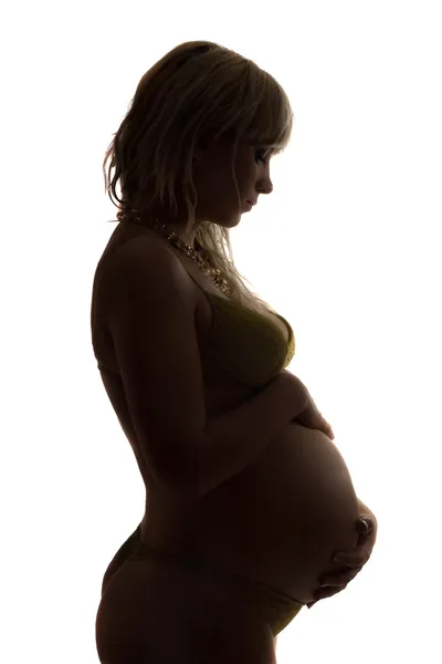 Silhouet van een zwangere jonge vrouw. geïsoleerd Rechtenvrije Stockafbeeldingen