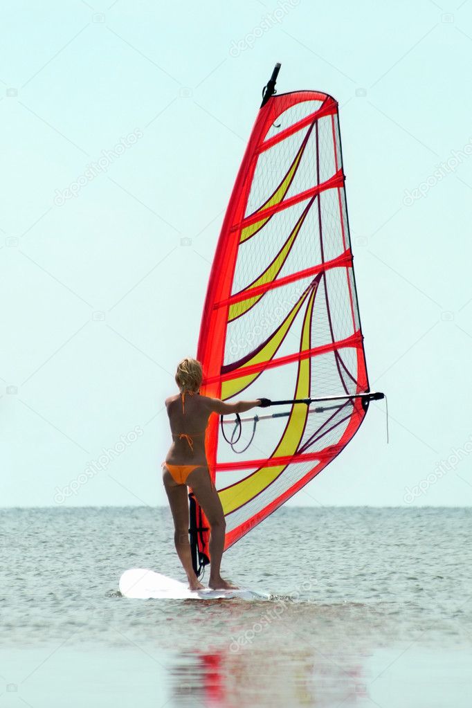Silhouette of a girl windsurfer