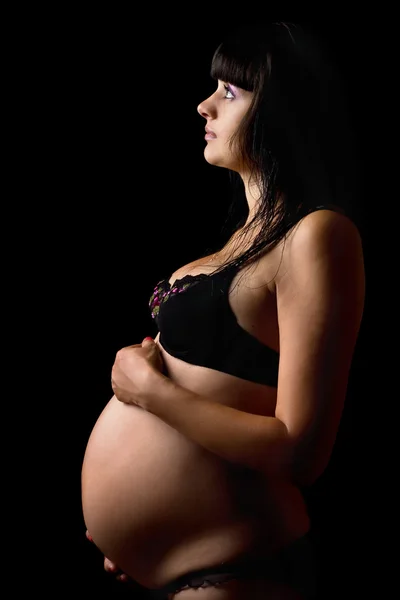 Zwangere jonge vrouw in lingerie. geïsoleerd — Stockfoto