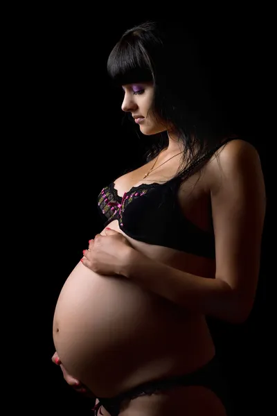 Ciąży brunetka w bieliźnie. na białym tle — Zdjęcie stockowe
