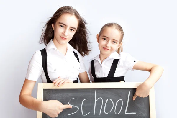 Schoolgirls about a schoolboard — Stock Photo, Image