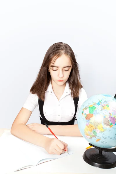 Schoolgirl writes the task — Stock Photo, Image