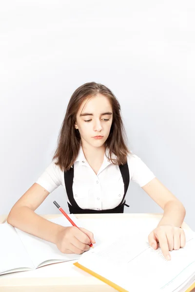 Schoolgirl writes the task — Stock Photo, Image