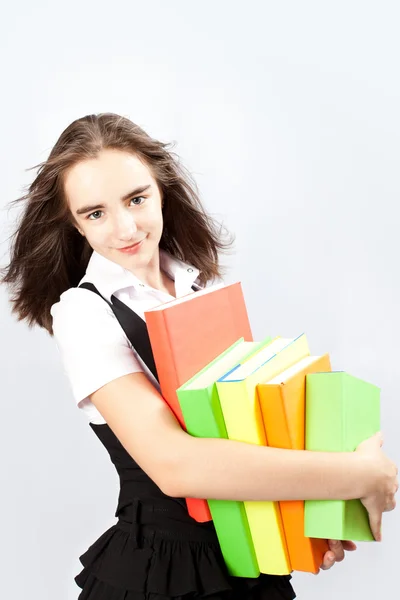 Schoolgirl holds books — Stock Photo, Image