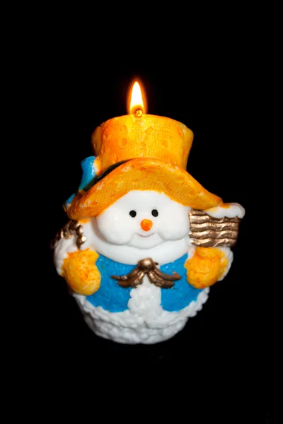 Plamen svíčky se sněhulákem — Stock fotografie