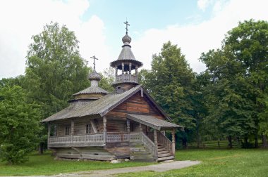 Aging wooden chapel in village clipart