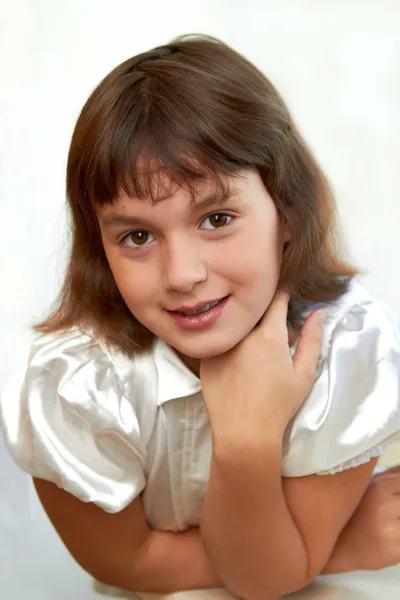 Όμορφο κοριτσάκι χαμογελώντας με το χέρι στο πηγούνι — Φωτογραφία Αρχείου