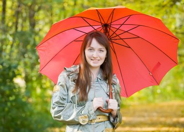 Girl with umbrella in autumn clipart