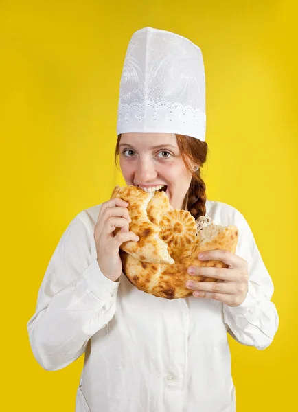 Woman is eating fresh loaf — Stock Photo, Image