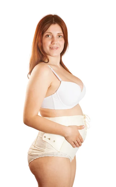 Zwangere vrouw moederschap gordel dragen — Stockfoto