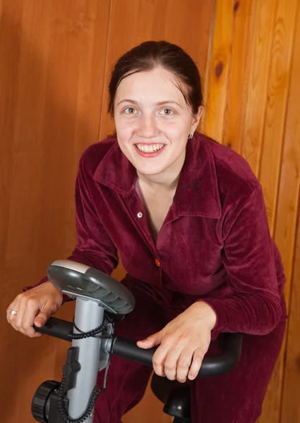 Woman exercise on exercycle — Stock Photo, Image