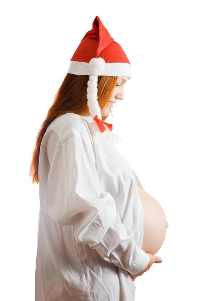 Těhotná žena v klobouku vánoční — Stock fotografie