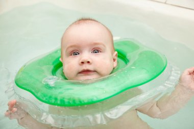 Six month swimming baby in bath clipart