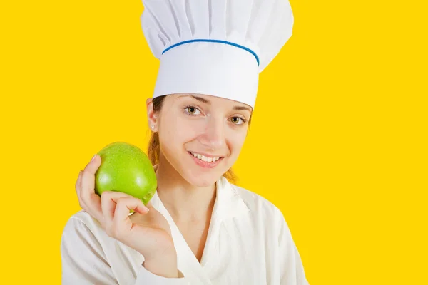 Köchin hält Apfel in der Hand — Stockfoto