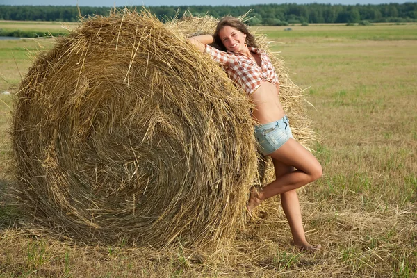 Girl on fresh straw — Stock Photo, Image