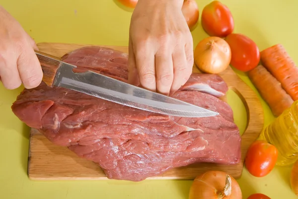 Cook hands cutting beef — Stock Photo, Image