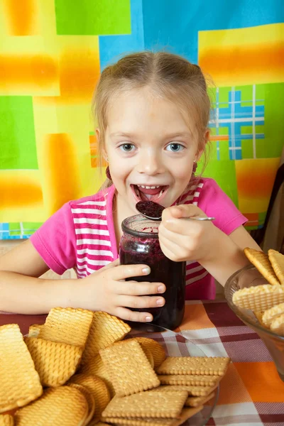 Little girl eating marmalade — Stock Photo, Image