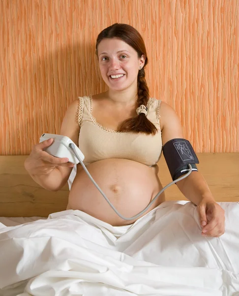 Pregnant woman measure blood pressure — Stock Fotó