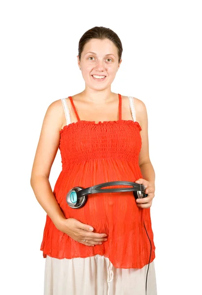 Mulher grávida com fones de ouvido na barriga — Fotografia de Stock