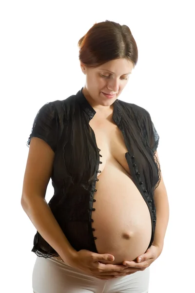 怀孕的女人看肚皮 — 图库照片