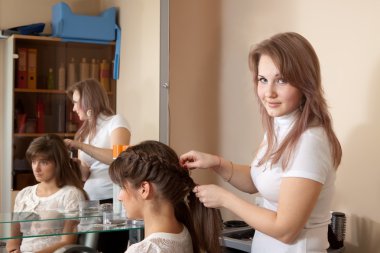 Hair stylist working with girl clipart