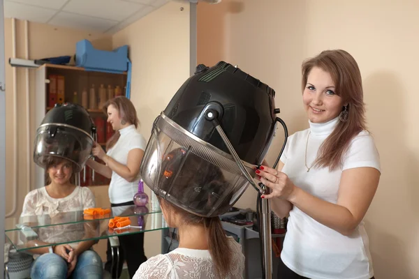 Hairdresser working with hair dryer — Stock Photo, Image