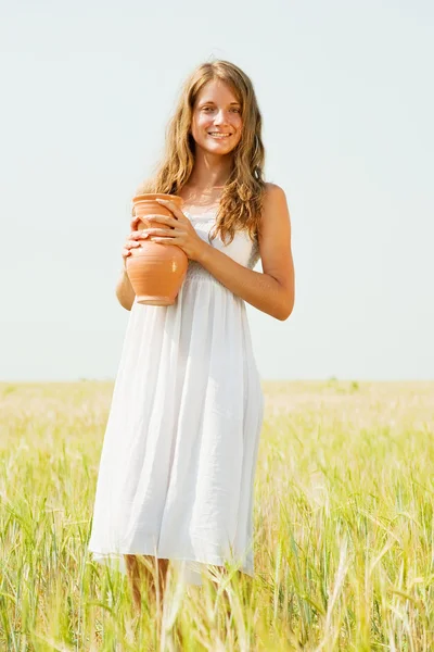Chica con jarra en el campo de cereales — Foto de Stock