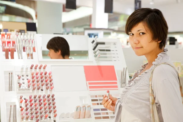 Woman is choosing lipstick — Stock Photo, Image