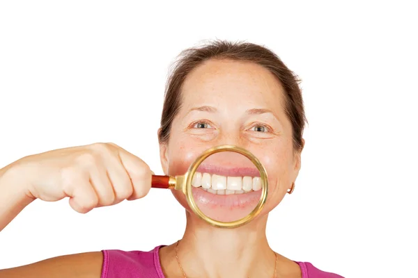 Teeth of mature woman through magnifier — Stock Photo, Image