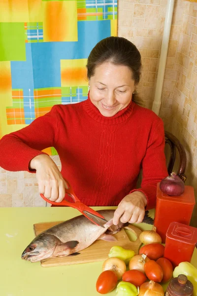 Woman cutting flippers with scissors — Stock Photo, Image