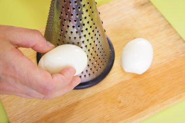 Closeup of grating eggs clipart