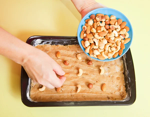 stock image Woman adds nuts into dough