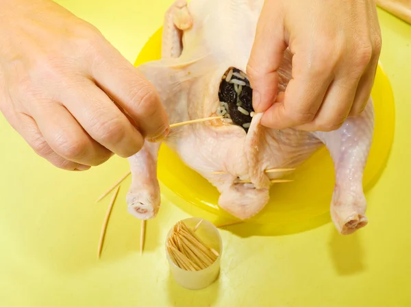 Cook sewing stuffed chicken — Stock Photo, Image
