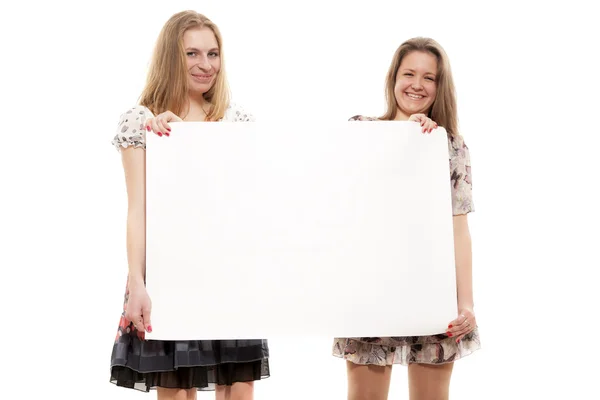 Two girls hold a paper blank leaf — Stock Photo, Image