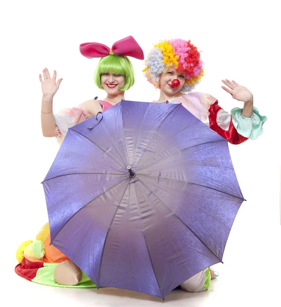 Κλόουν, πίσω από μια ομπρέλα κύμα χέρια στο χωρίστρα — Φωτογραφία Αρχείου