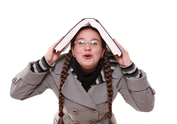 Schoolgirl with a book on her head — Stock Photo, Image