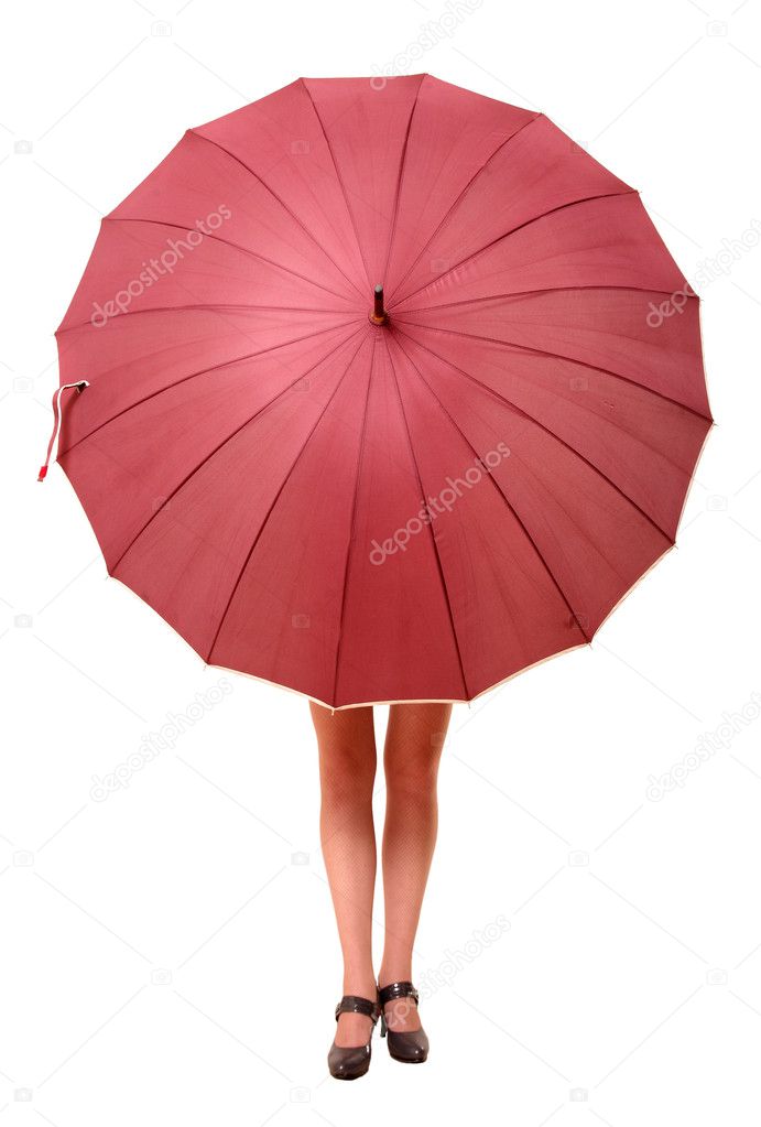 The girl hides behind the big umbrella from under which feet stick out only