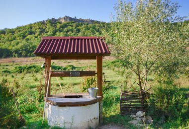 The old well in the countryside clipart