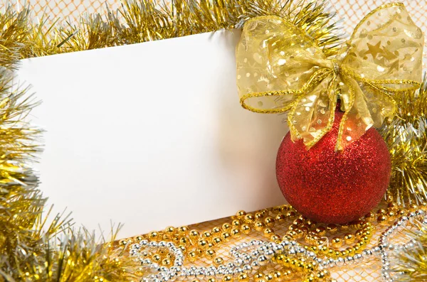 Christmas ball with tinsel and postcard — Stock Photo, Image