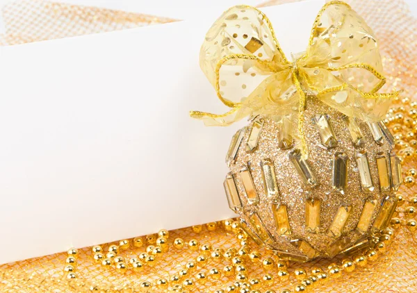 Christmas ball with bow and postcard — Stock Photo, Image