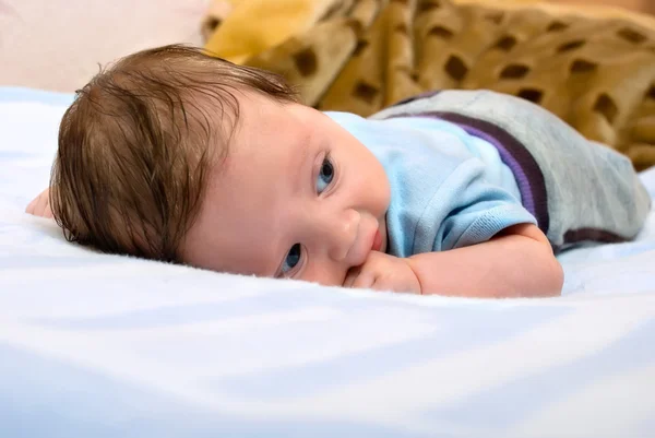 Baby lies on stomach — Stock Photo, Image