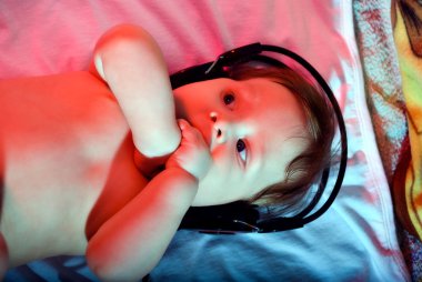 Small baby listening to music