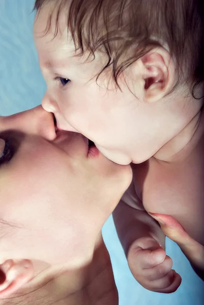 Beautiful baby kissing his mother — Stock Photo, Image