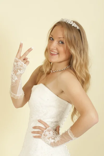 Girl in the bride's dress with arm raised — Stock Photo, Image