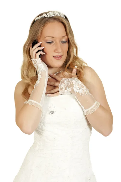 Girl in a wedding dress talking on the phone — Stock Photo, Image