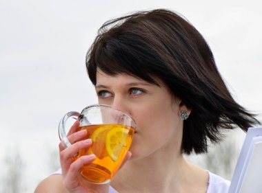 Young woman drinking tea clipart