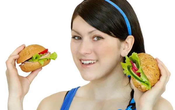 Mujer joven comiendo sándwich, aislado sobre fondo blanco — Foto de Stock