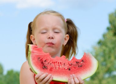 Little girl eating watermelon clipart