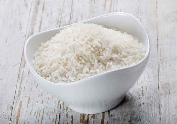 Rice on a wooden table — Stock Photo, Image