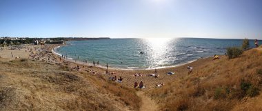 Crowded summer beach in Crimea, Ukraine clipart